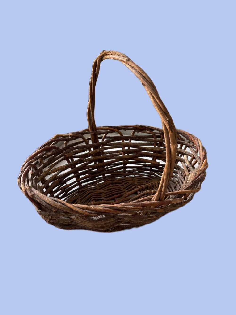 Handwoven vintage twig gathering basket with handle.